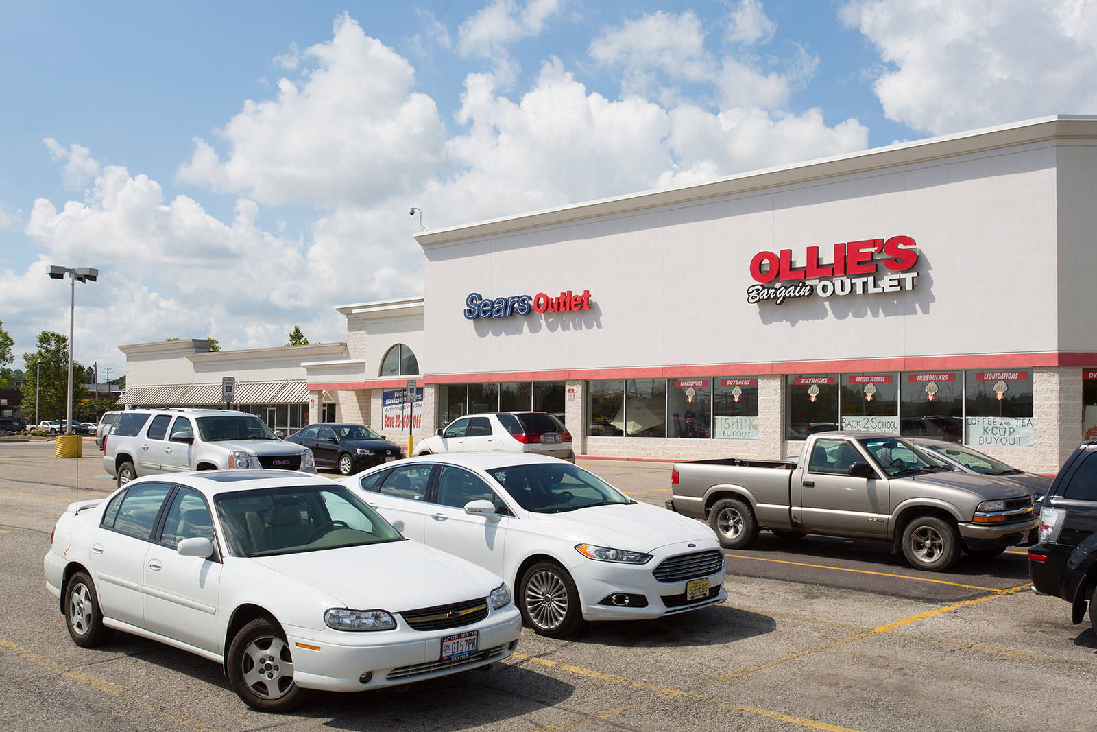 Car parked in the parking lot of Sears Outlet nad Ollie's 