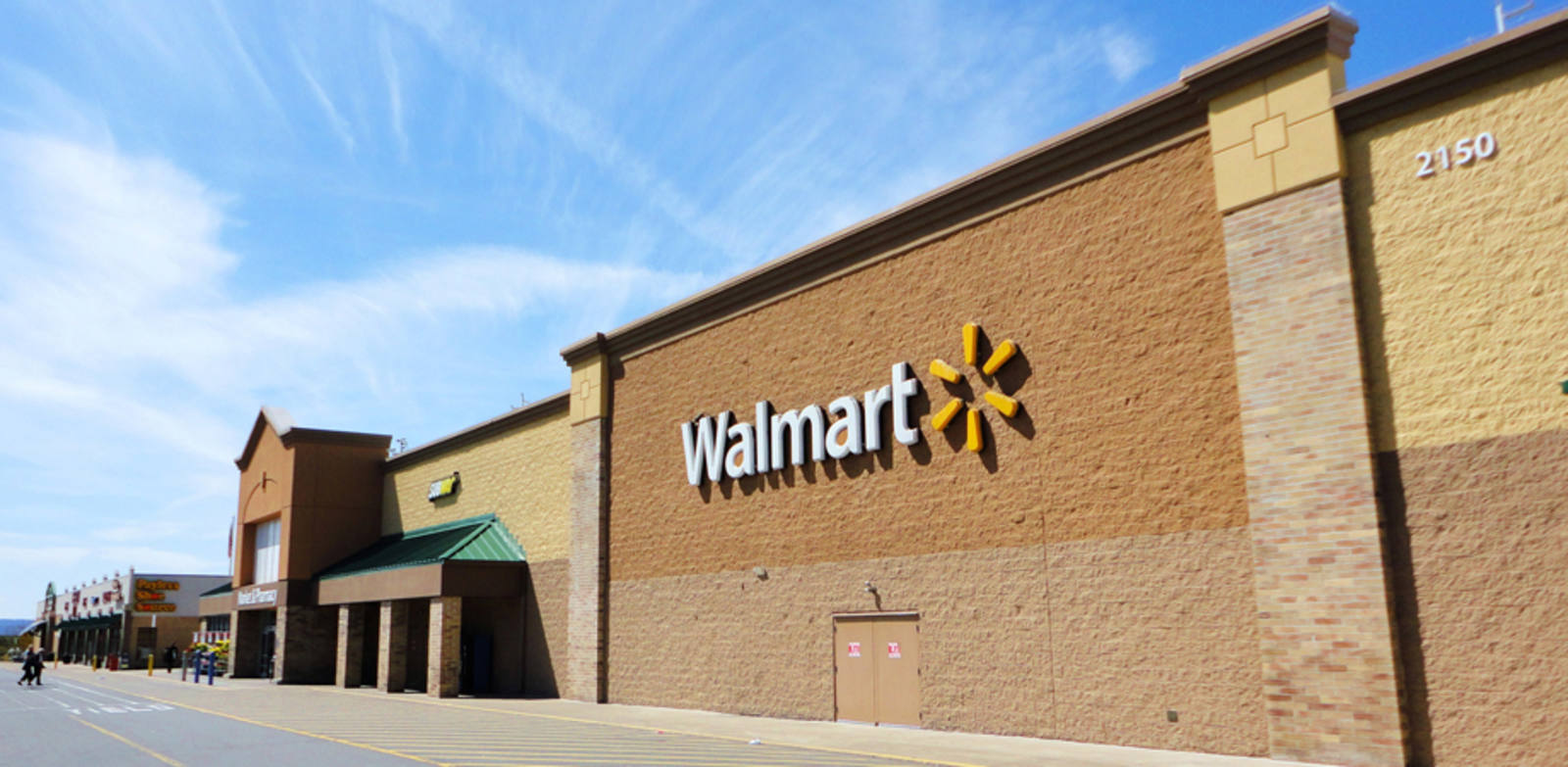 Shoppers and a blue sky in front of Walmart at Wilkes Barre, PA.