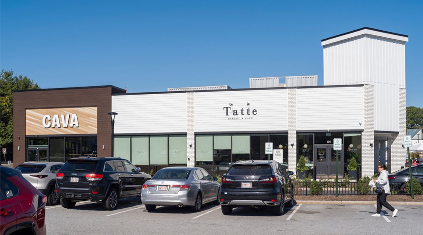 CAVA and Tatte Bakery & Café storefronts at Burlington Square in Burlington, MA, featuring a modern retail center façade and a busy parking area at this high‑traffic shopping plaza.