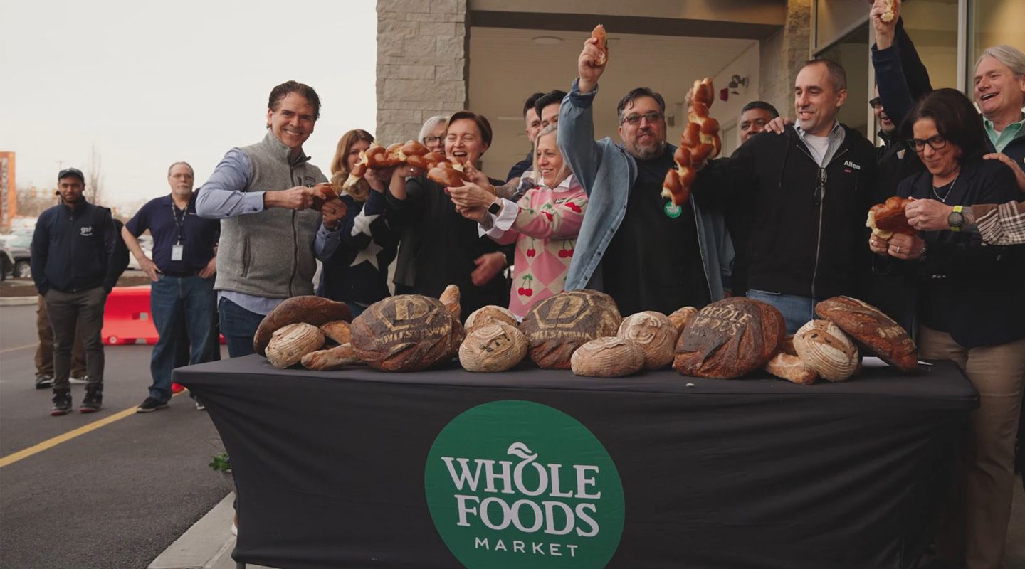 Group of Whole Foods Market employees celebrating grand opening of Barn Plaza shopping center